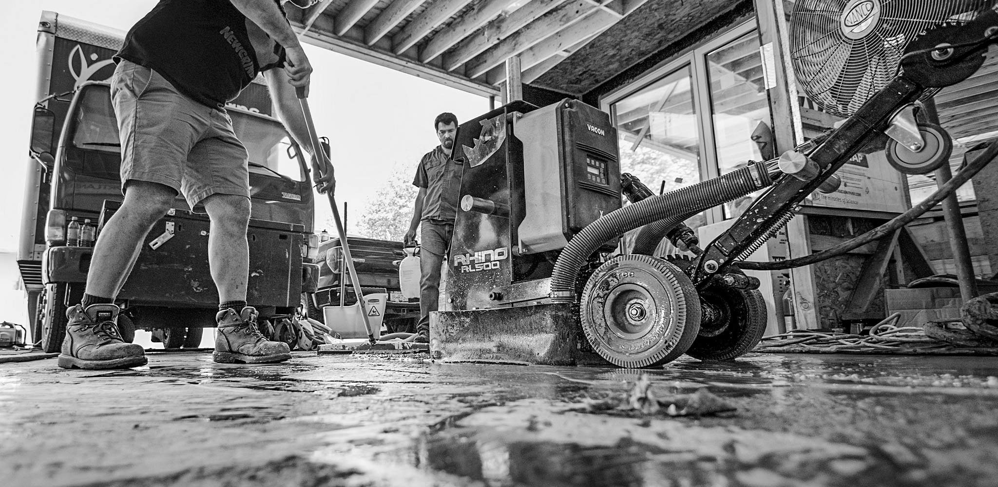 NewGrind team members using the Rhino RL500 to grind a concrete garage floor.